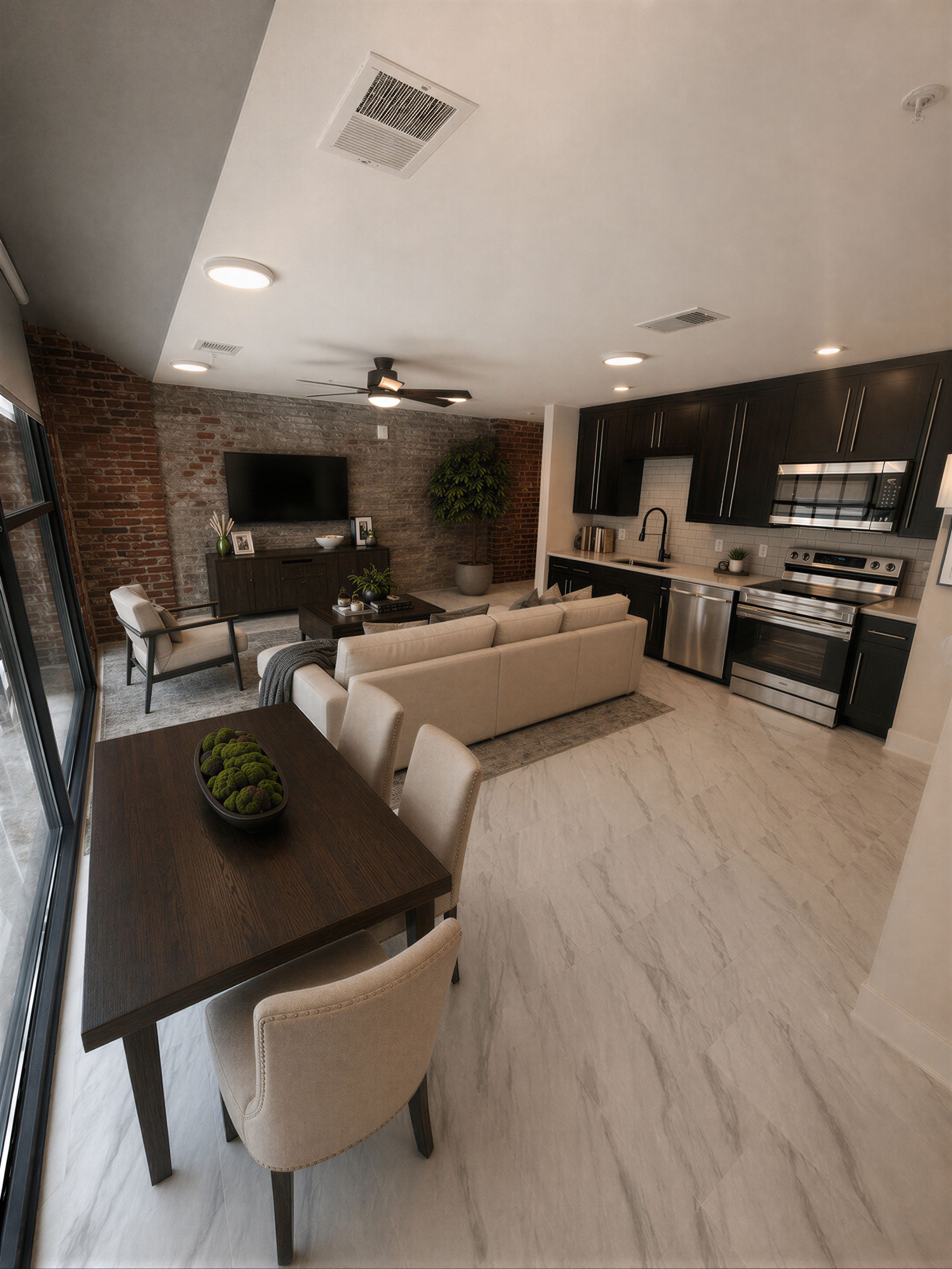 1-bedroom luxury apartment interior with exposed brick wall, open kitchen and dining area at The Power House Rock Hill SC