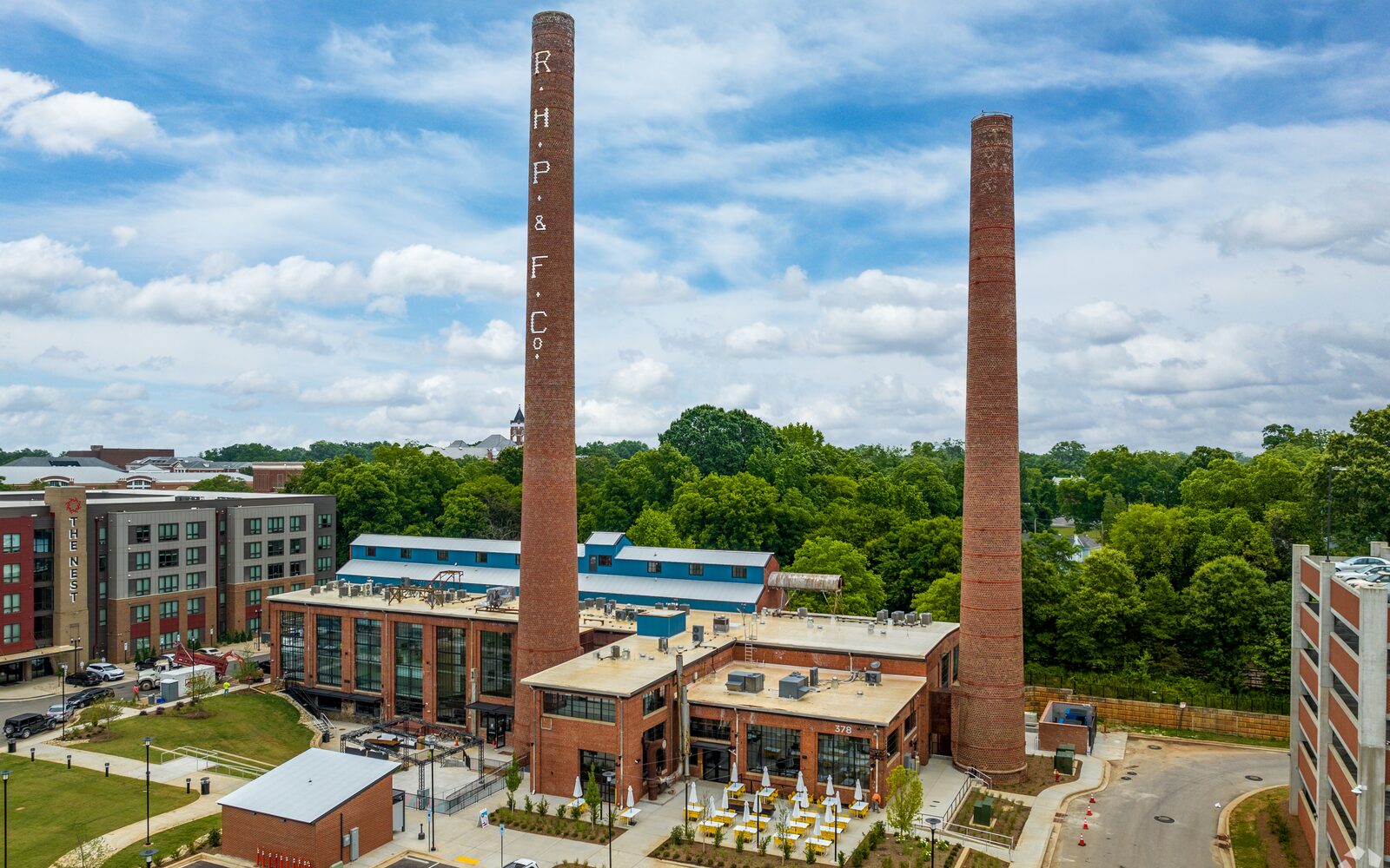Aerial view of The Power House Apartments historic brick exterior and smokestacks in Rock Hill, SC