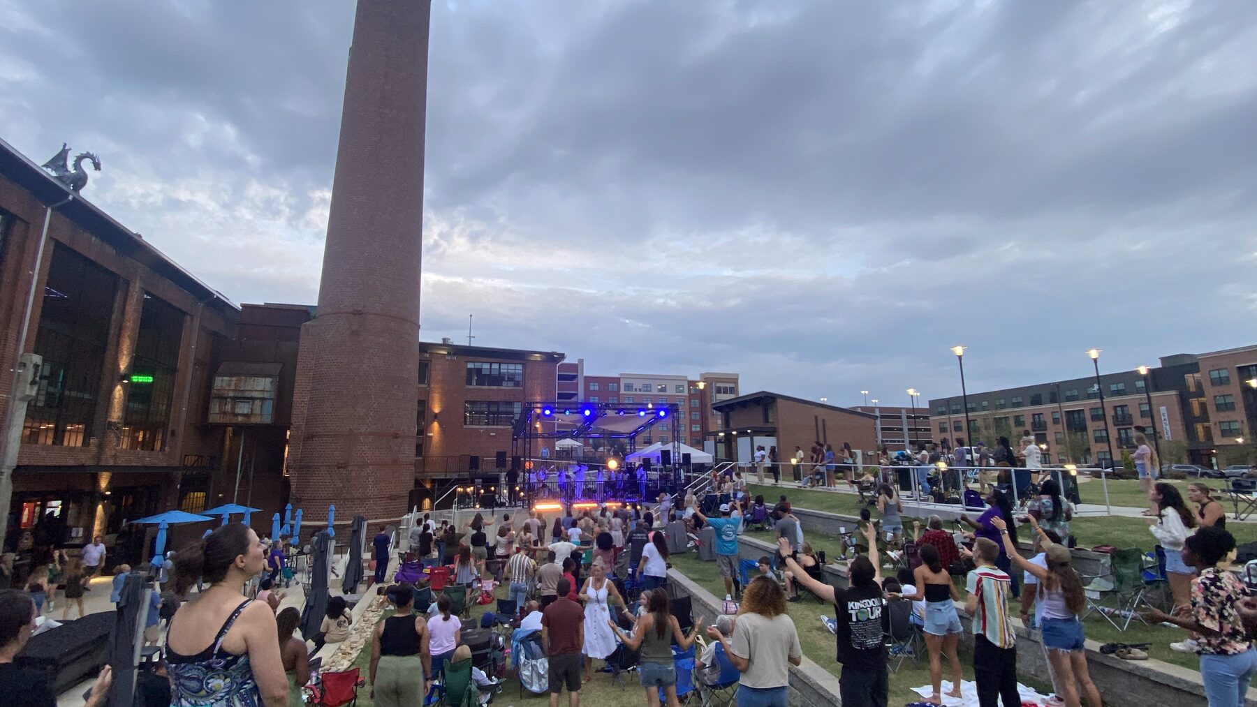 Outdoor event lawn and stage at The Power House Apartments, a pet-friendly community in Rock Hill, SC