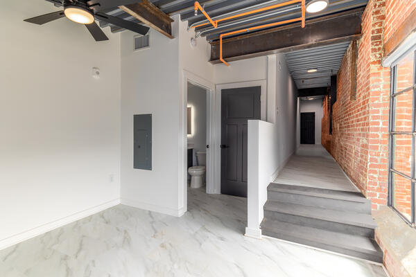 Spacious loft interior with high ceilings, exposed beams, and natural light at The Power House Apartments in Rock Hill, SC