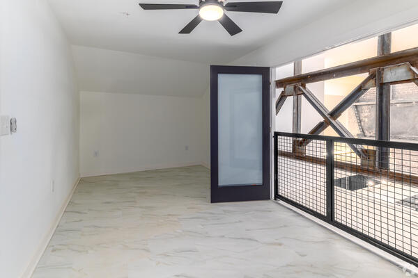 Oversized factory window overlooking downtown Rock Hill from a two-story Power House loft apartment