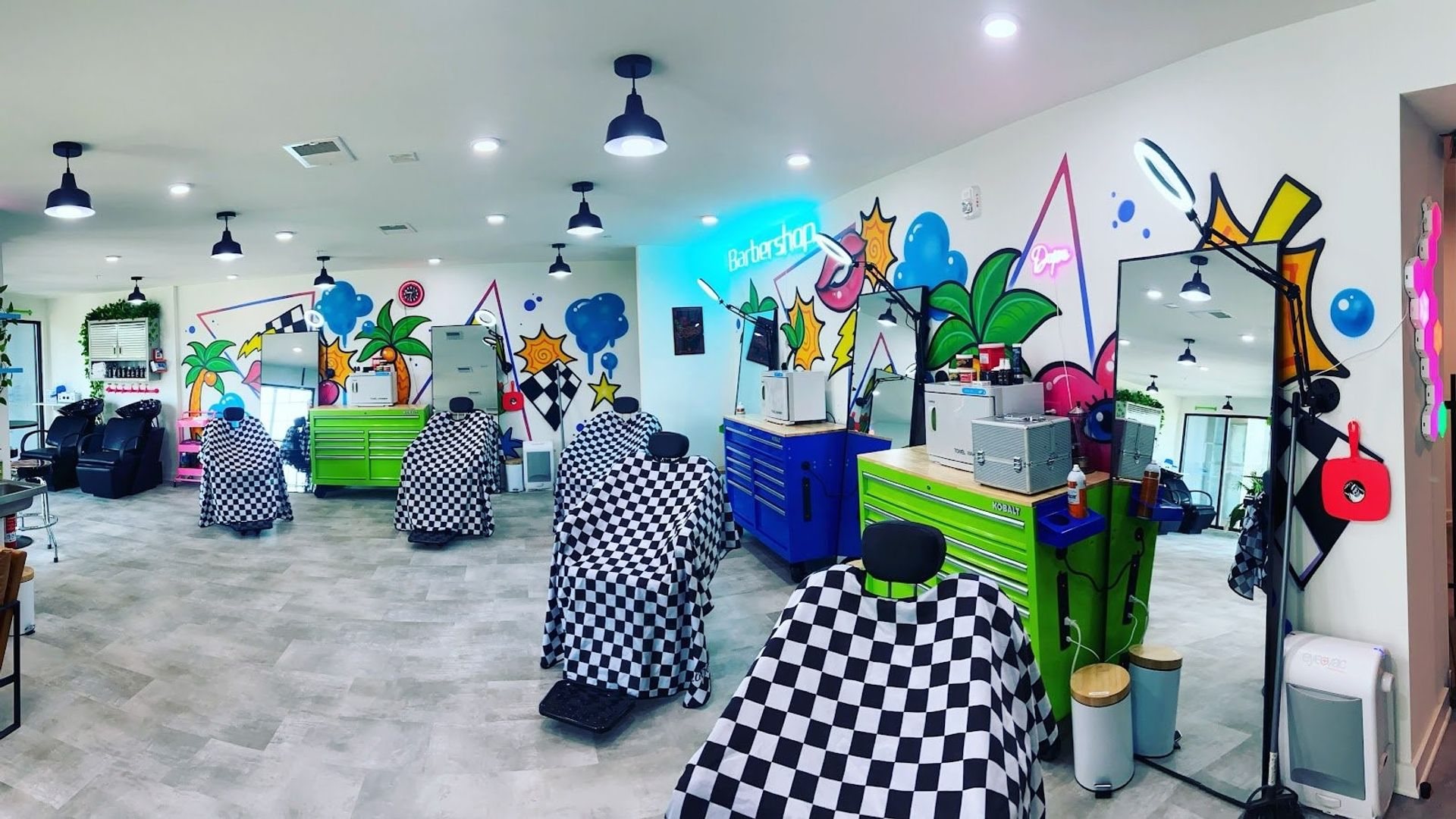 Suite 1212 set up as a barbershop with chairs, stations and two shampoo bowls