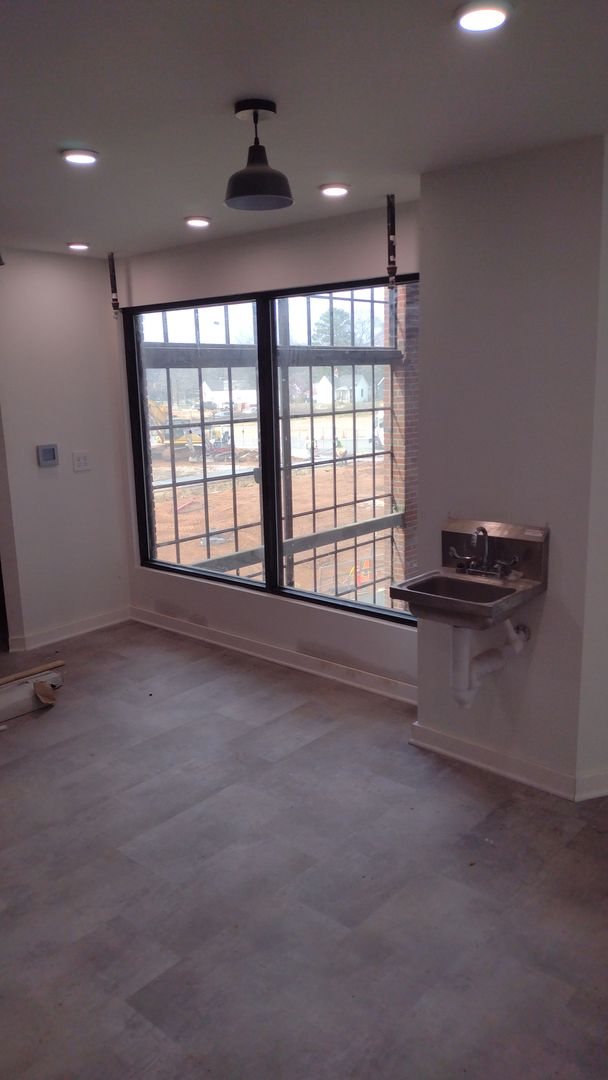 Factory-style window and stainless hand sink in Suite 1212